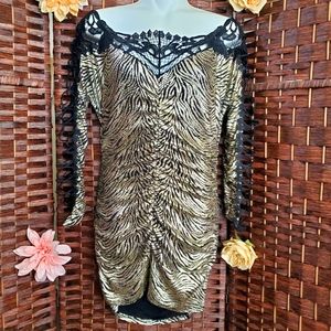 mini Dress the color is gold on the sleeves are in the form of embroidery betwee